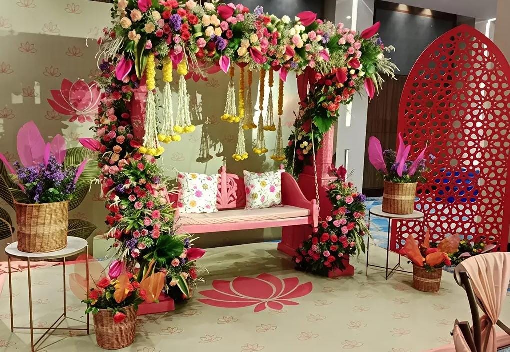 Krishna theme naming ceremony backdrop with floral arch decoration in Delhi